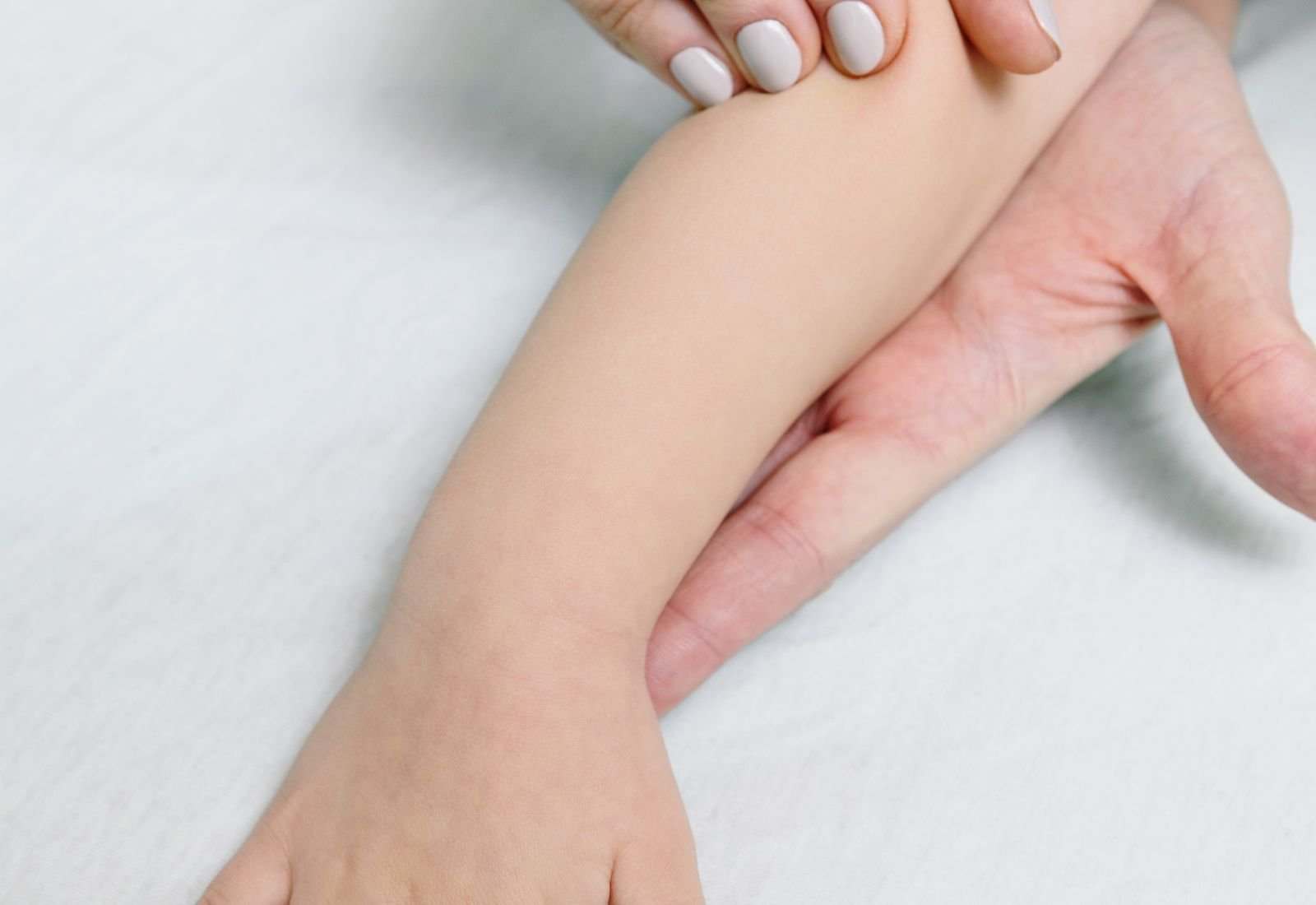A physical therapist treating a patient on the plinth